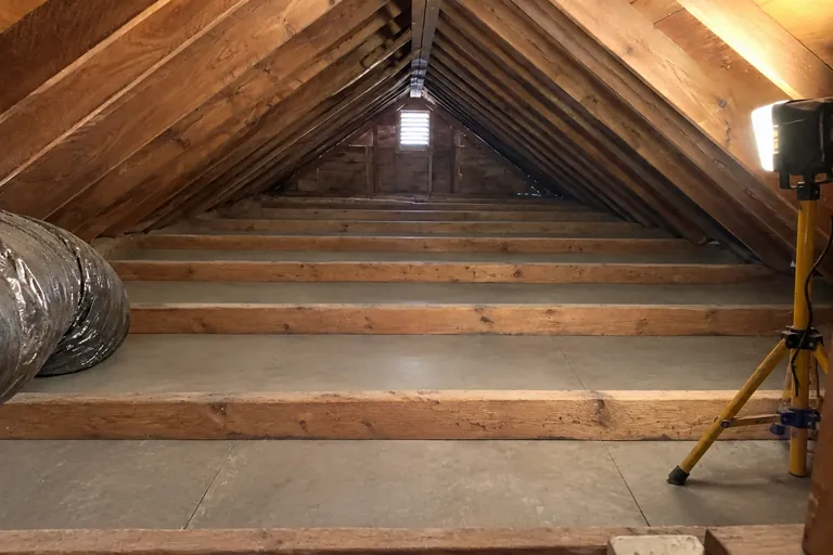 Attic after cleaning: everything removed down to clean joists